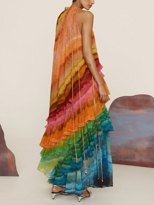 Colorful print ruffle women's maxi dress by FJØRNA, perfect for summer, featuring vibrant patterns and flowy fabric.