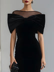 FJØRNA black velvet bow midi dress featuring a fitted silhouette, elegant neckline, and classic bow detail for formal occasions.