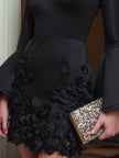 FJØRNA black floral appliqué long-sleeve mini cocktail dress with elegant floral details and fitted silhouette.
