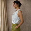 FJØRNA women's satin cowl neck sleeveless top in cream, mock neck design, elegant and smooth fabric for stylish wear.
