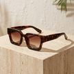 FJØRNA vintage 90s rectangular unisex sunglasses with retro style, accessory for women, black frame and tinted lenses.