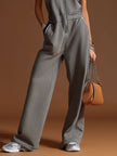 FJØRNA dark grey cotton blend sleeveless zip-up jumpsuit with pants style and zipper front, displayed on a mannequin.