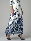 FJØRNA women's floral summer maxi dress with V-neck and wrap design, flowing fabric and vibrant floral pattern.
