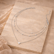 Gold 3-layer pearl pendant necklace set for women, layered jewelry accessory from FJØRNA with elegant pearl details.