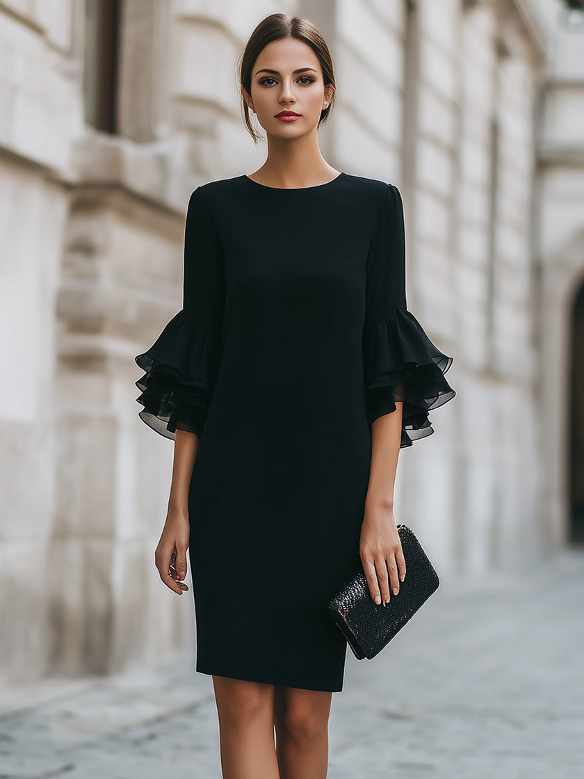 FJØRNA black ruffled sheer sleeve midi cocktail dress displayed on model with elegant design and flowing silhouette.