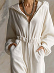 White corduroy hooded zip-front long sleeve jumpsuit for women by FJØRNA, featuring a stylish and comfortable design.