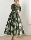 White satin midi dress for women by FJØRNA featuring off-shoulder design, bodycon fit, and printed pattern.