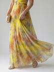FJØRNA women's sleeveless summer maxi dress with wrap style, flowing fabric and vibrant floral pattern.