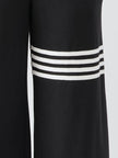 FJØRNA black sleeveless hooded jumpsuit with striped pants for women, featuring a casual, stylish design and a hooded top.