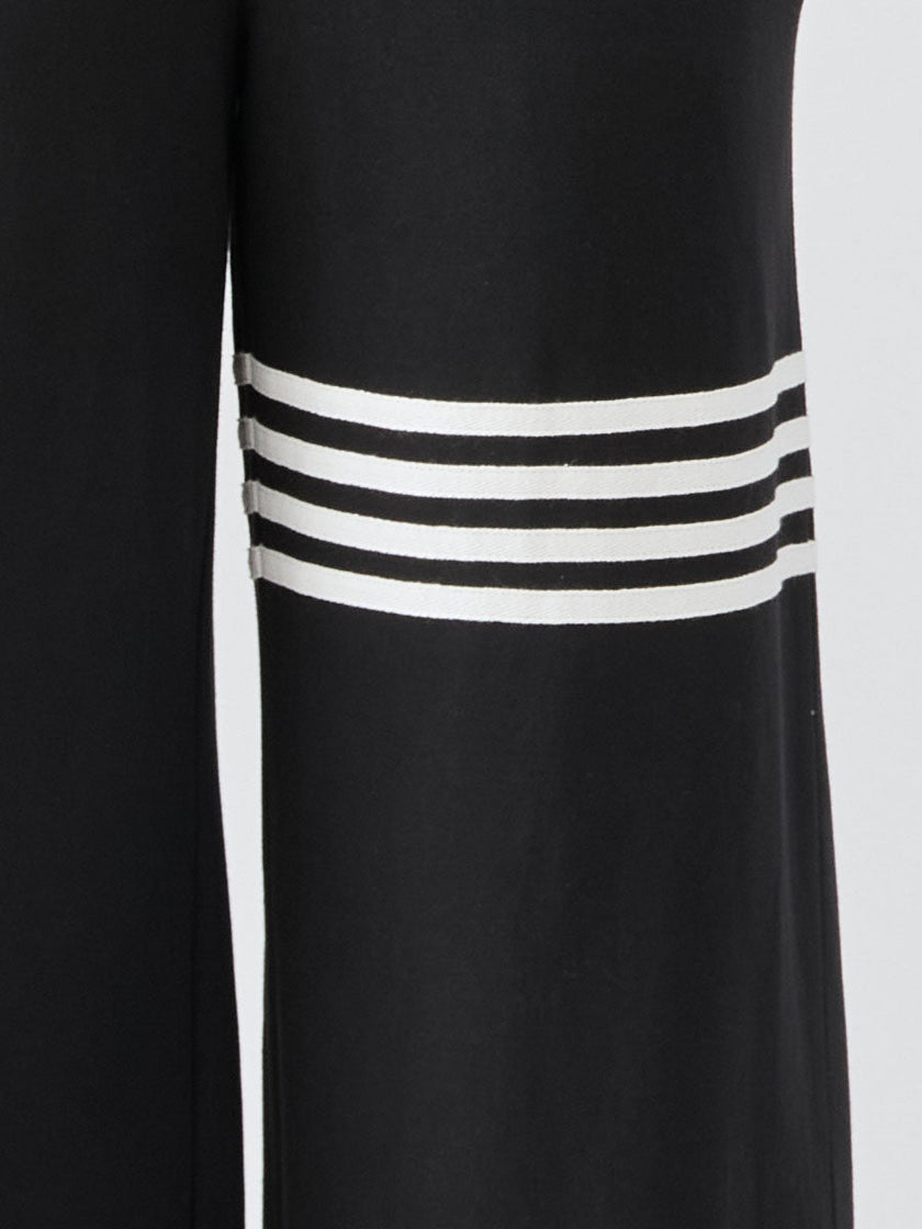 FJØRNA black sleeveless hooded jumpsuit with striped pants for women, featuring a casual, stylish design and a hooded top.
