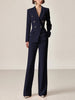 FJØRNA navy women's double-breasted two-piece suit set with lapel collar, including tailored pants, displayed on a hanger.