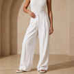 FJØRNA women's high-waist wide-leg tailored trousers with a loose fit and pull-on design, styled on a model.