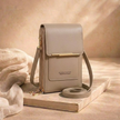 FJØRNA anti-theft crossbody bag for women, compact travel shoulder bag with secure zipper and adjustable strap.