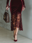 Burgundy velvet maxi dress by FJØRNA featuring a flowing silhouette and elegant evening dress design.