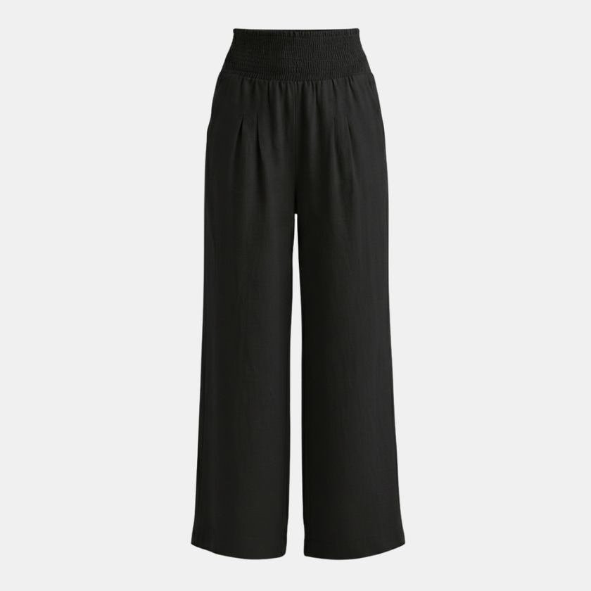 White high waist wide leg trousers for women by FJØRNA, showcasing the relaxed fit and smooth fabric.