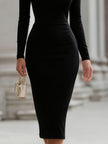 FJØRNA black off-the-shoulder long-sleeve sheath dress for cocktails, featuring a fitted silhouette and elegant design.