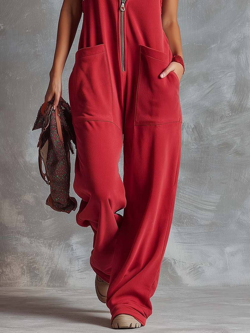 Raspberry red cotton hooded zip-front jumpsuit for women, featuring a relaxed fit and functional pockets, by FJØRNA.