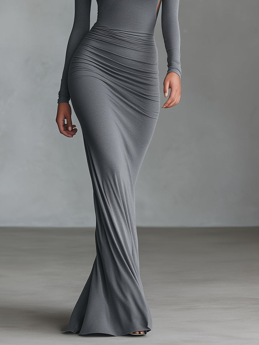 Grey knit ruched maxi dress by FJØRNA, featuring a fitted silhouette and elegant evening style, shown on a model.