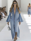Light blue denim flared wide-leg jumpsuit with long sleeves for women, by FJØRNA, shown on a model.