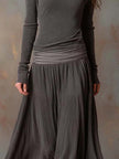 Charcoal knit maxi dress for women by FJØRNA, featuring a flowing silhouette and soft fabric.