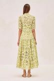 FJØRNA Ledina Midi Green Dress, elegant sleeveless dress with a flowy silhouette and V-neckline, on a model.