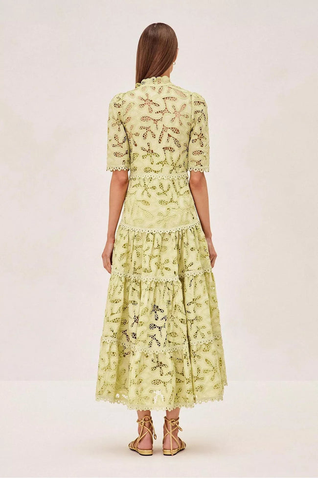 FJØRNA Ledina Midi Green Dress, elegant sleeveless dress with a flowy silhouette and V-neckline, on a model.