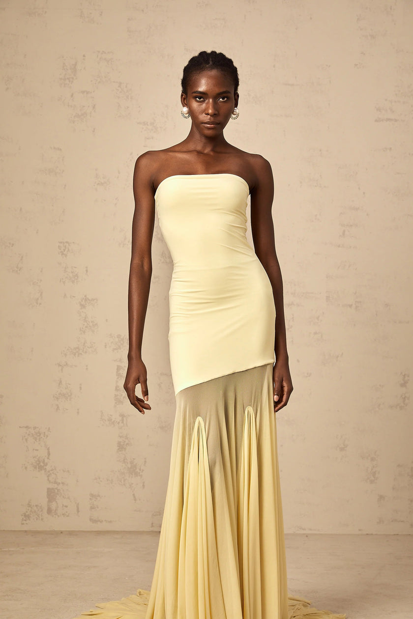 FJØRNA yellow off-shoulder sheer tulle maxi dress for women, elegant evening dress with flowing design and black tie detail.