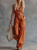 Rust orange cotton women's sleeveless V-neck jumpsuit with western-style pants by FJØRNA, shown in a full-length view.