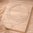 Gold layered pearl pendant necklace set for women featuring three delicate chains with pearl accents, by FJØRNA accessories.