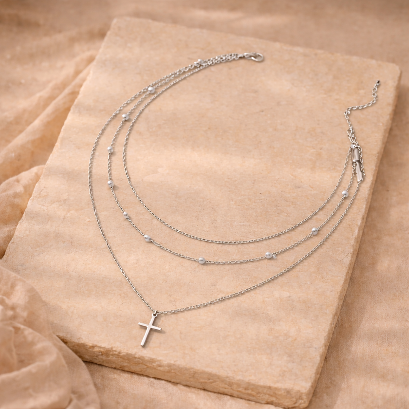 Gold layered pearl pendant necklace set for women featuring three delicate chains with pearl accents, by FJØRNA accessories.