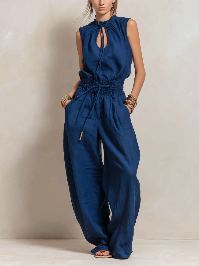 Dark blue cotton-linen women's jumpsuit by FJØRNA with round neck, sleeveless design, slim-fit, and pants style.
