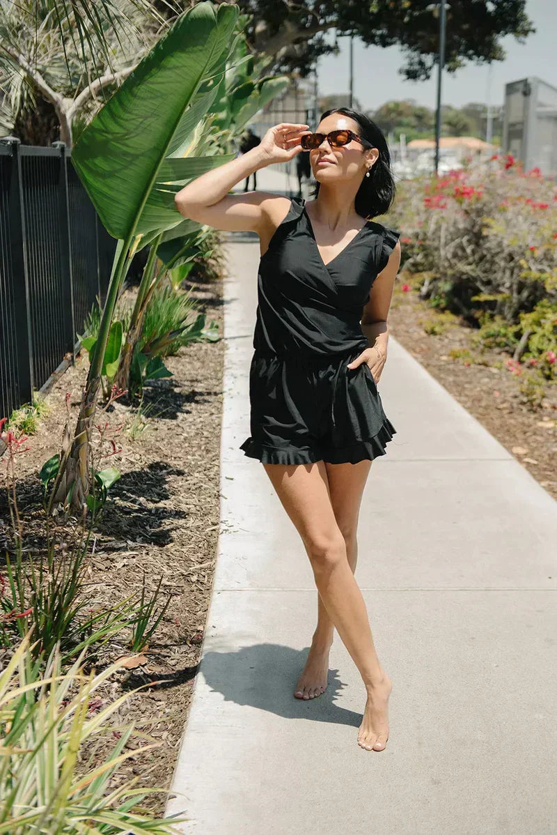 FJØRNA women's summer tankini set with ruffles and V-neck, featuring a colorful swim top and matching bottoms for beachwear.