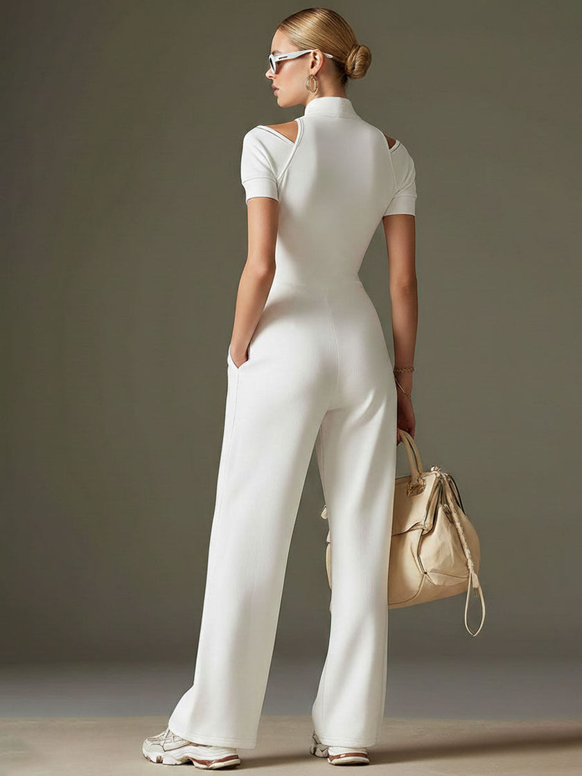 White cotton blend short sleeve wide-leg jumpsuit for women by FJØRNA, shown on a hanger with flowing fabric and wide-leg style.