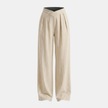 Women’s criss-cross waist wide-leg trousers by FJØRNA, loose pull-on pants in lightweight fabric, shown in a relaxed fit.