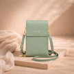 FJØRNA touchscreen crossbody phone bag for women, featuring a sleek design and transparent phone compartment for easy access.