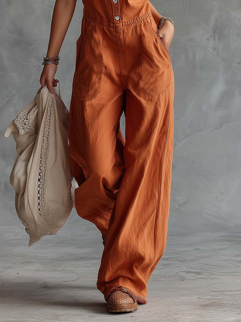 Rust orange cotton Western V-neck sleeveless jumpsuit for women, featuring wide-leg pants from FJØRNA.
