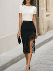 Cream lace evening dress by FJØRNA featuring intricate lace details and a flowing silhouette for elegant occasions.