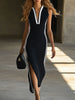 Black knit V-neck maxi dress for women by FJØRNA, featuring a flowing silhouette and long sleeves.