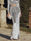 Black FJØRNA long sleeve ruched cutout evening gown with elegant design and fitted silhouette, perfect for formal occasions.