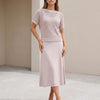 Apricot FJØRNA women's two-piece knit cropped set with a fitted top and matching high-waisted pants, stylish and comfortable.