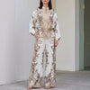 Apricot floral two-piece women's co-ord set with wide-leg pants and matching top by FJØRNA, stylish and elegant for warm weather.
