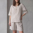 Apricot FJØRNA women's two-piece co-ord set with pockets, V-neck top, and lightweight fabric, styled for casual wear.