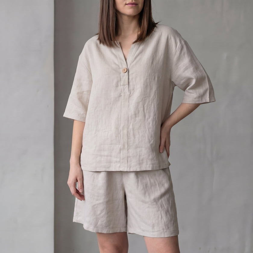 Apricot FJØRNA women's two-piece co-ord set with pockets, V-neck top, and lightweight fabric, styled for casual wear.