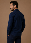 Men's FJØRNA classic button-up shirt in relaxed fit, perfect for smart casual outfits, shown on a model with rolled sleeves.