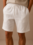 Men's cotton linen shorts by FJØRNA with a relaxed fit, ideal for summer casual wear, shown in a comfortable, laid-back style.