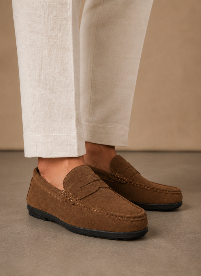 FJØRNA men's suede driving loafers, soft and comfortable slip-on shoes, shown in a stylish natural pose.