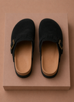 Men's suede slip-on clogs by FJØRNA, featuring a comfortable design for everyday wear, shown in a close-up of the shoe's upper.