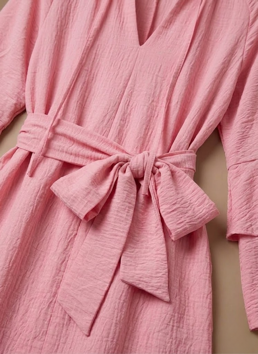 FJØRNA women's ruffle hem mini dress with long sleeves and belted waist, showcasing a stylish and feminine dress design.