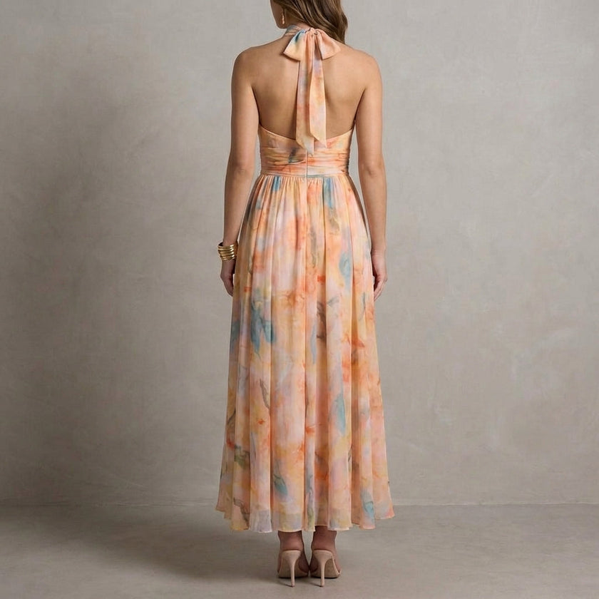 FJØRNA elegant women's maxi dress with halter neck and flowing fabric, shown from the back in this stylish dress image.