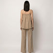 Back view of FJØRNA women's summer two-piece wide-leg co-ord set in lightweight fabric, featuring a cropped top and matching pants.